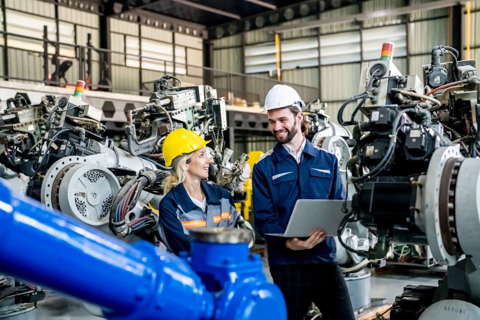 Engineer with robot in automotive parts factory